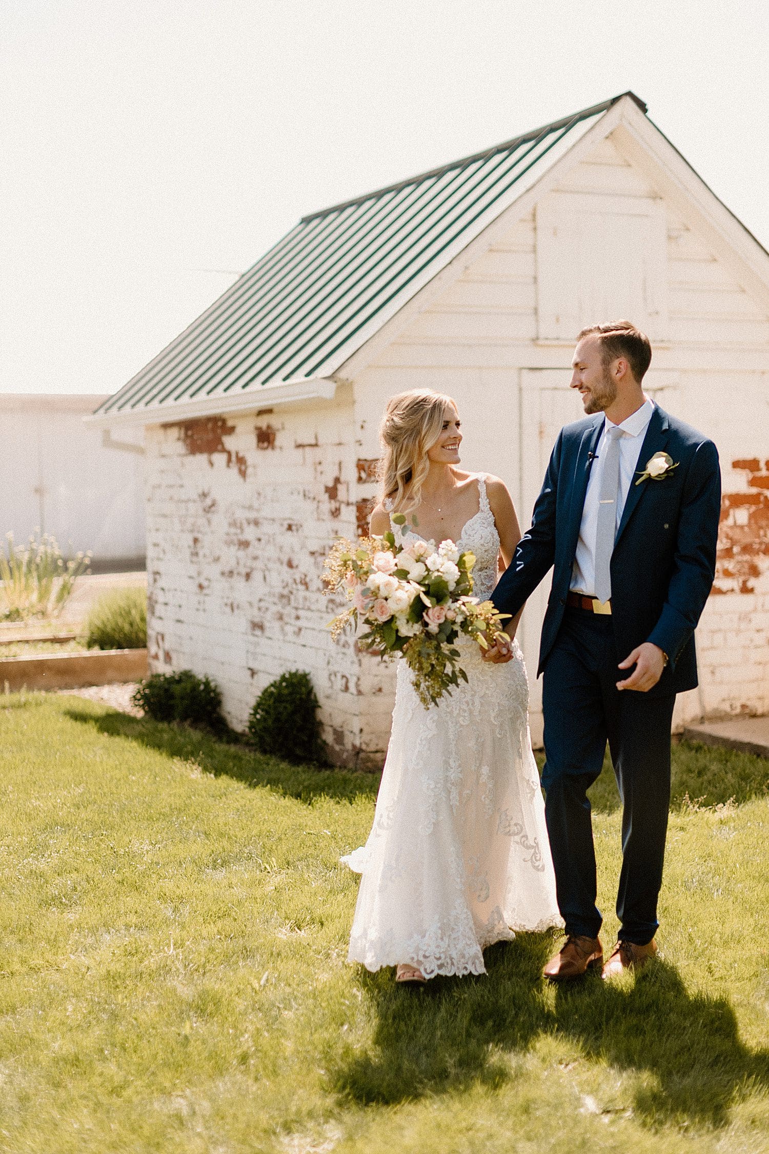 A bride and groom taking portraits at The Butler Barn.