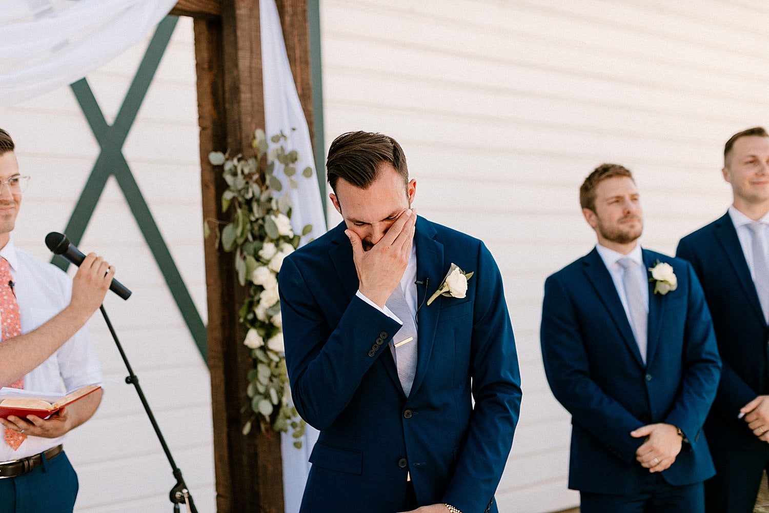 A groom crying at his wedding at The Butler Barn.