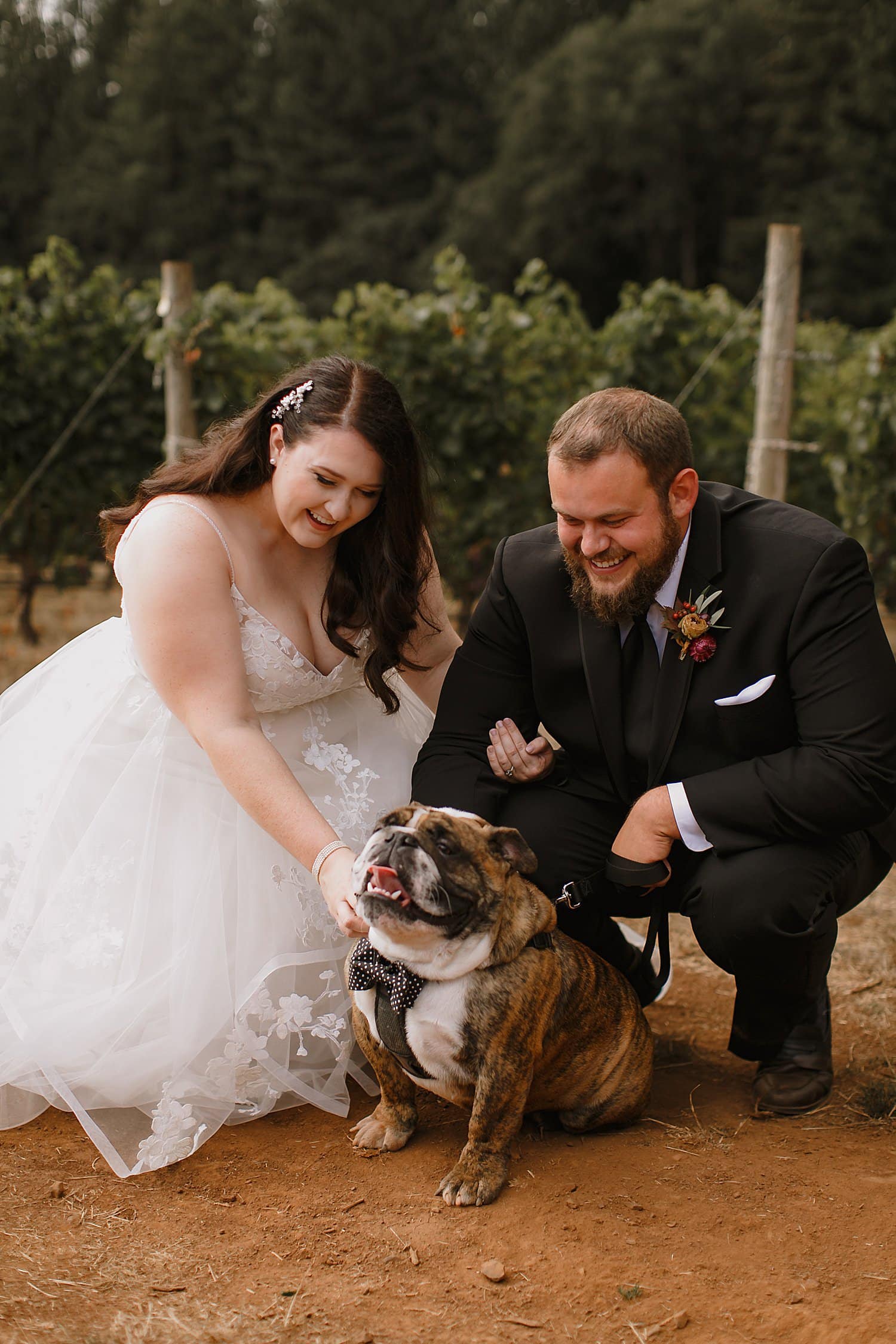 A bride and groom poses with their dog at their Domaine de Broglie wedding.