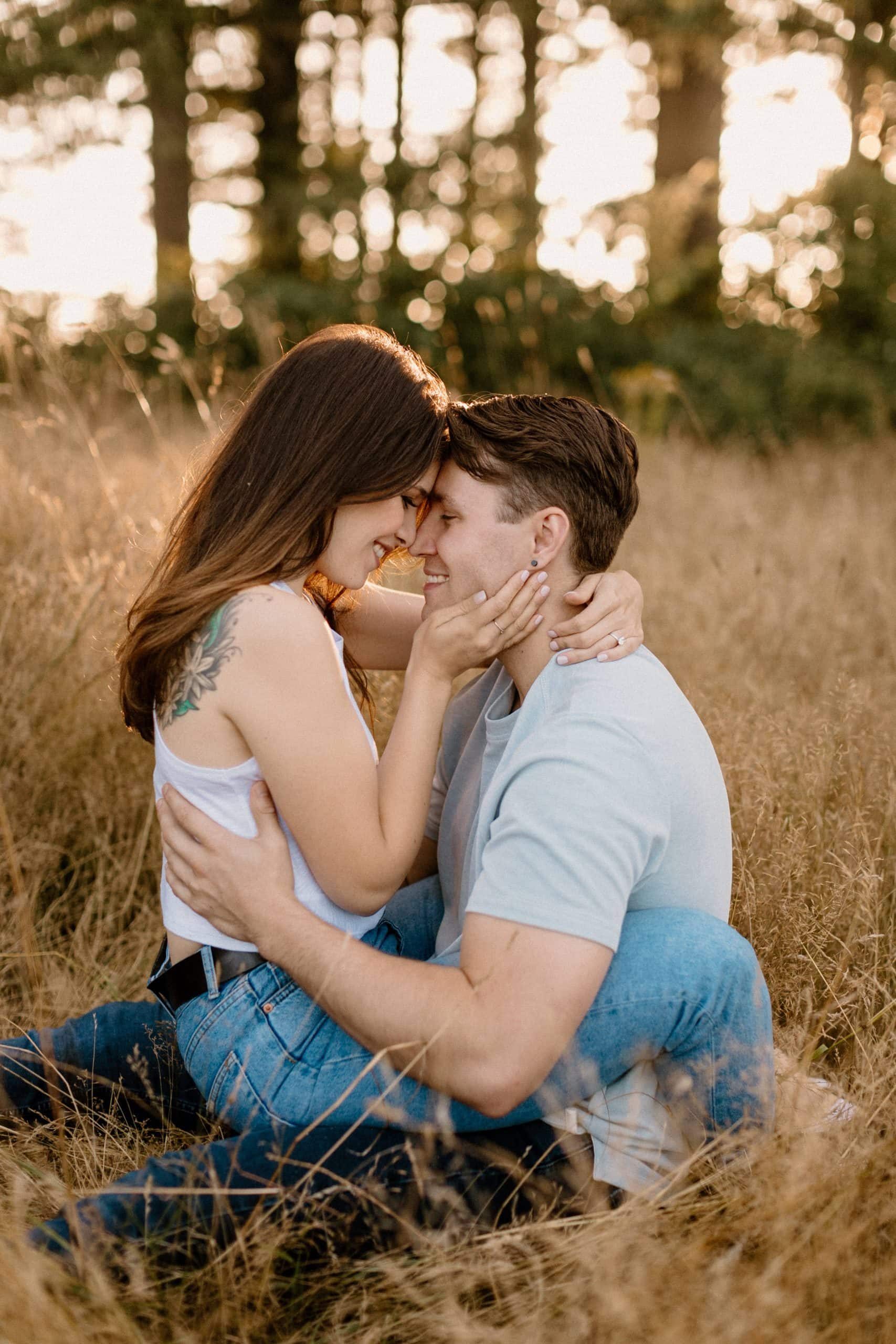 a couple sitting in the grass during their Portland engagement session.