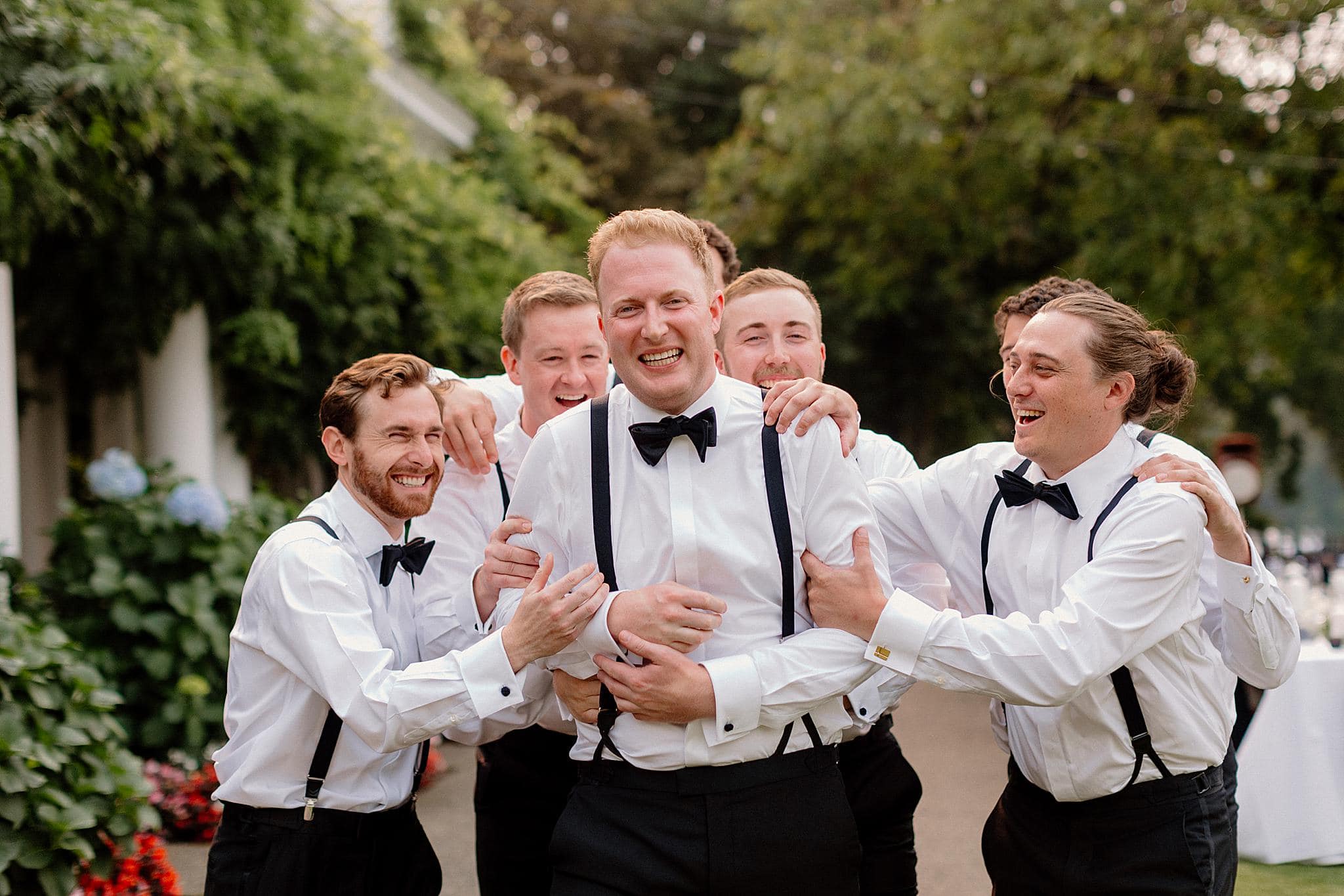Groomsmen share a candid moment at a wedding in Lake Oswego, Oregon. 