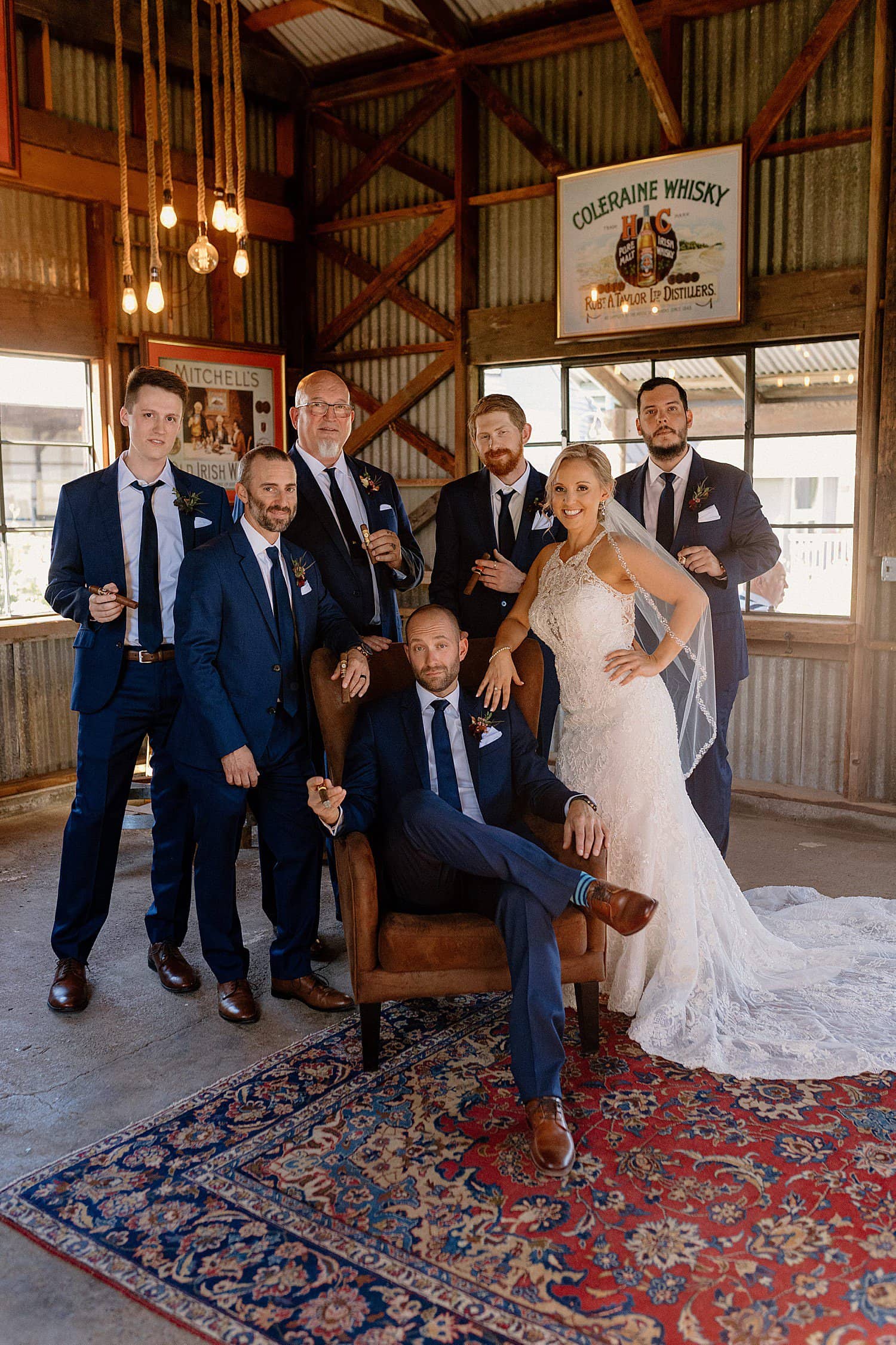 Groomsmen pose with a bride at Abbey Road Farm.