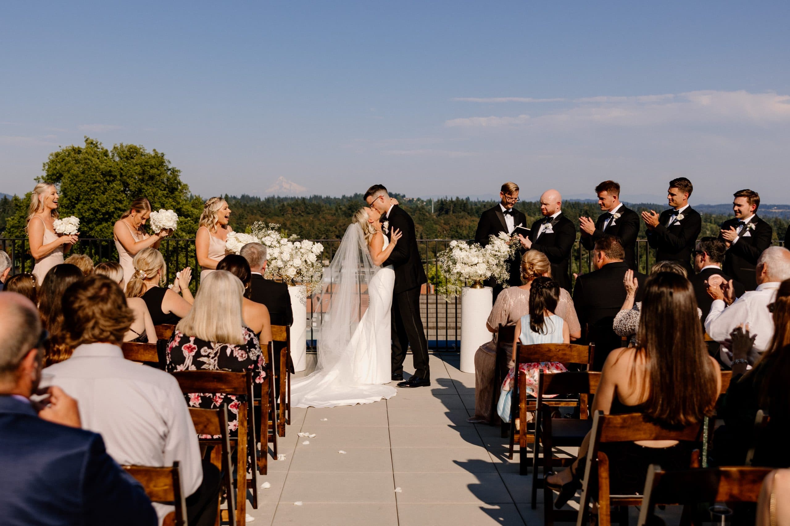 A bride and groom's first kiss at their Ironlight Lake Oswego wedding ceremony.