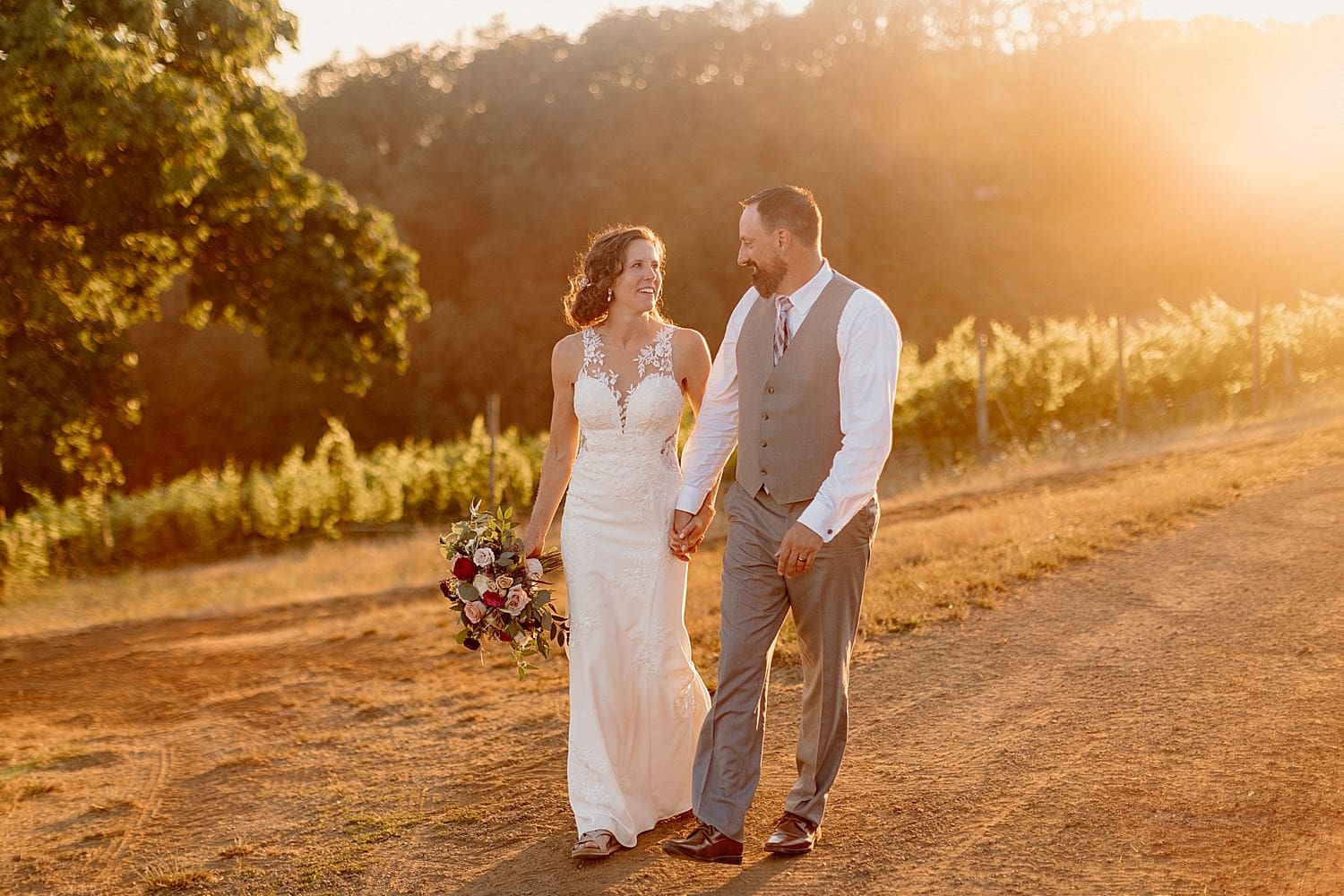 A bride and groom taking sunset portraits at their Maysara winery wedding.