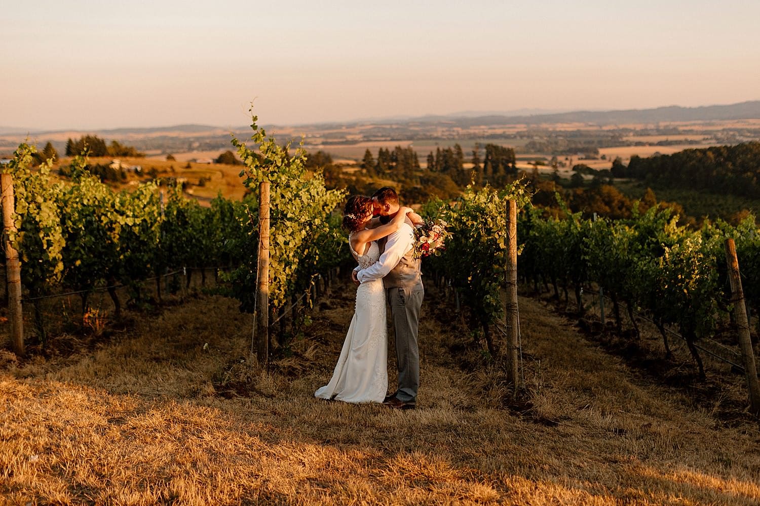 A bride and groom taking sunset portraits at their Maysara winery wedding.