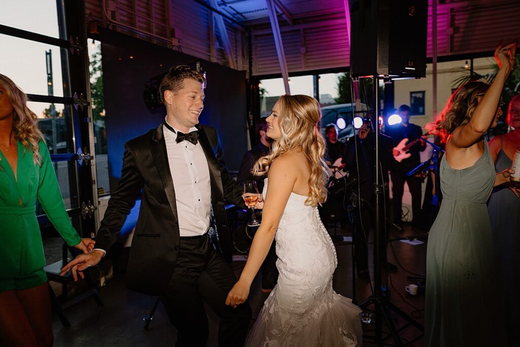 A bride and groom dancing along with Blue Wave Band at their Cooper's Hall wedding reception.