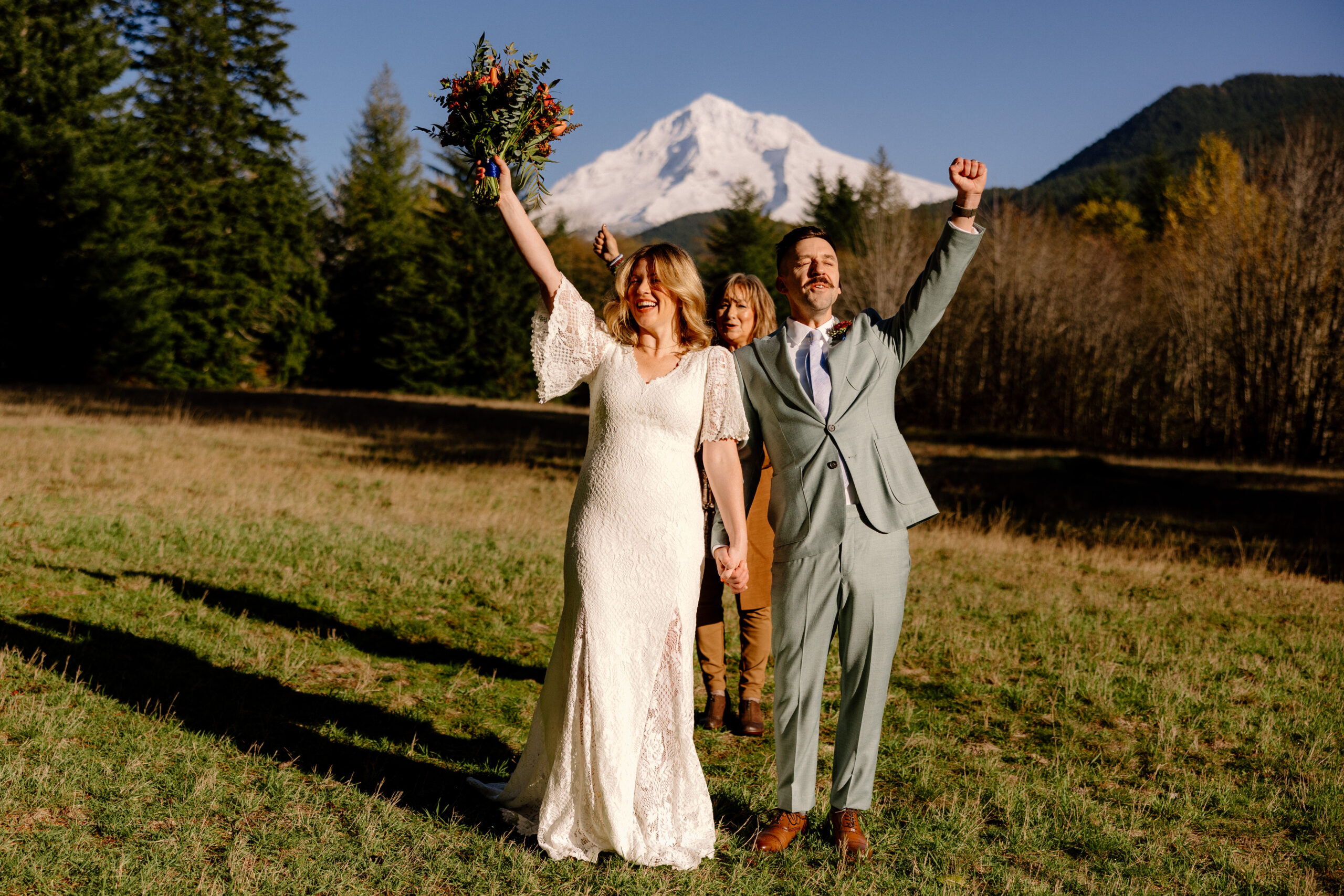 A bride and groom cheer after their Mt Hood Elopement ceremony.