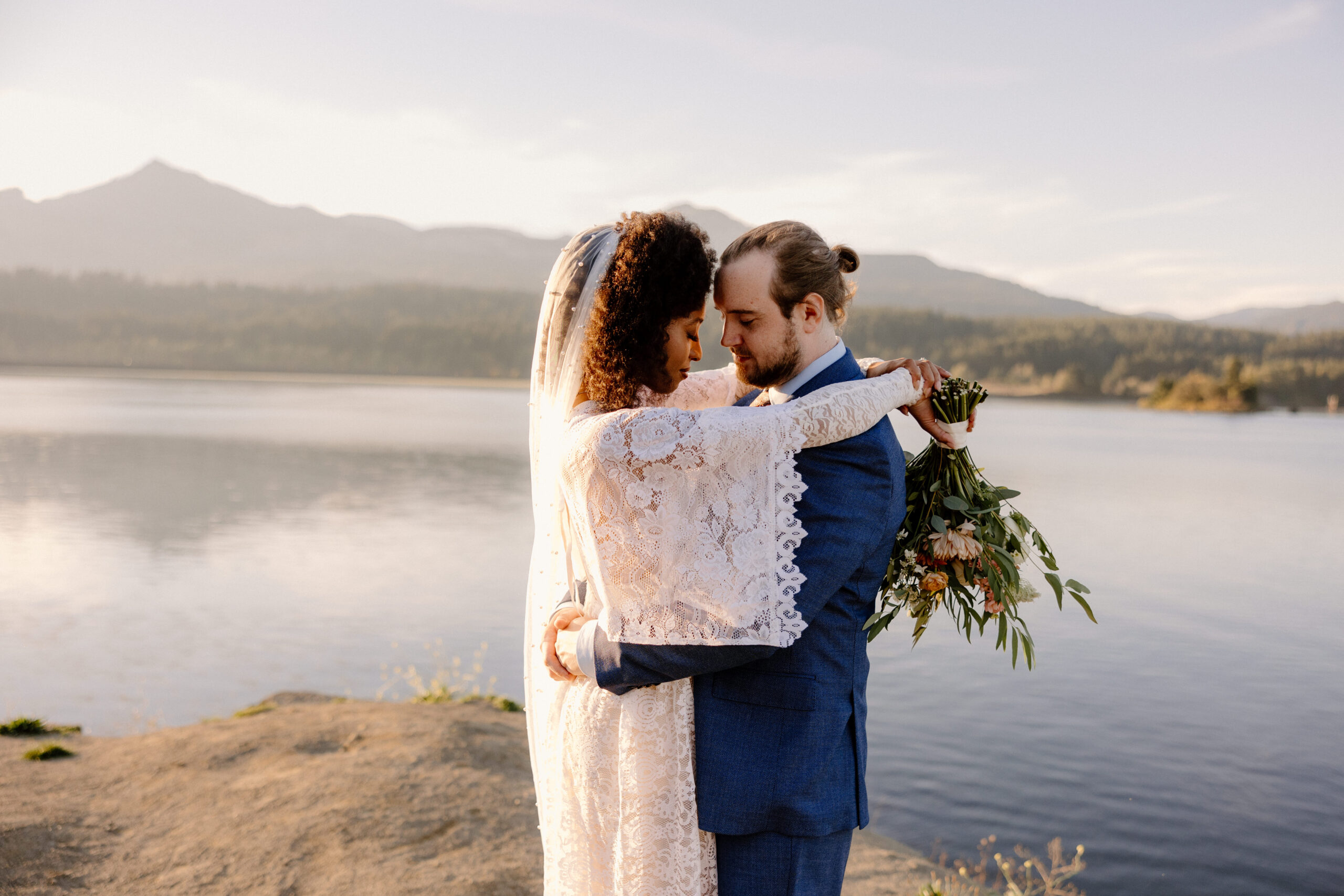 A couple embracing during sunset photos at their Columbia River Gorge elopement.