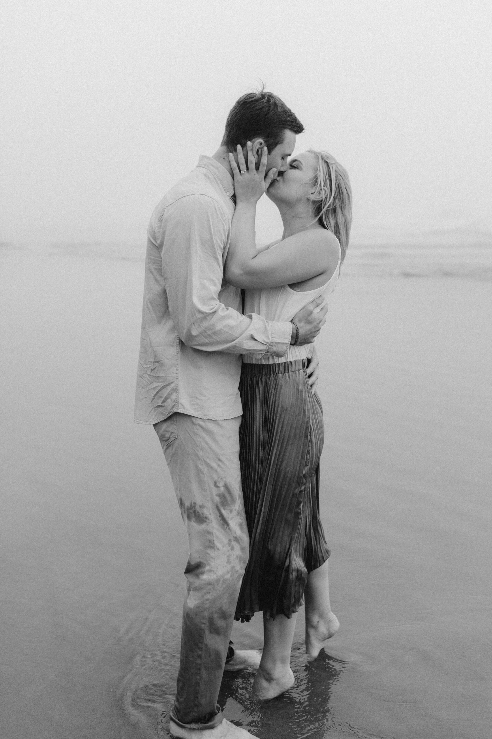 A couple kisses passionately during their Cannon Beach engagement session.