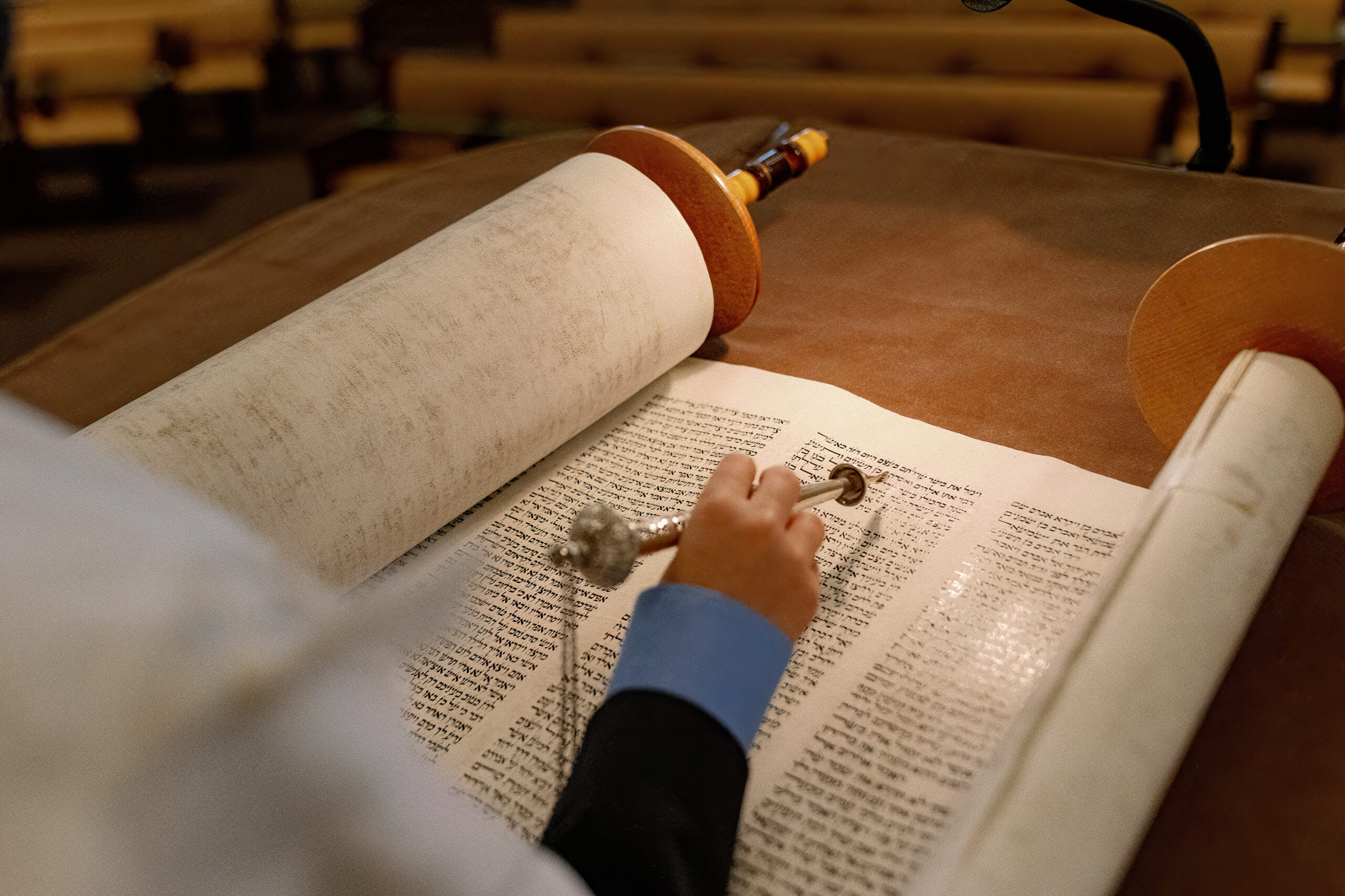 A child pointing to the torah with a yad during his bar mitzvah service at Congregation Nevah Shalom.