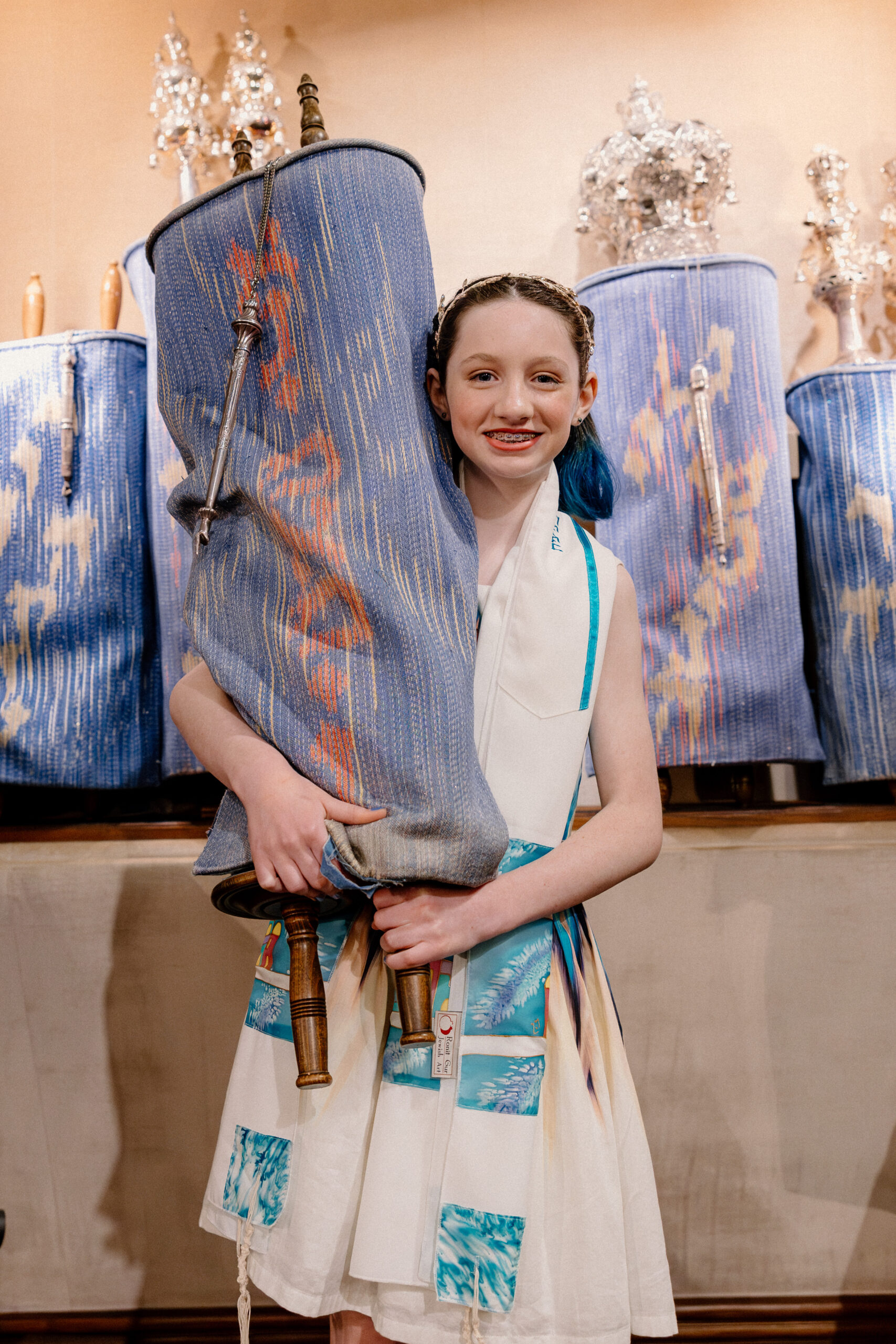 A bat mitzvah girl holding the torah at Congregation Beth Israel