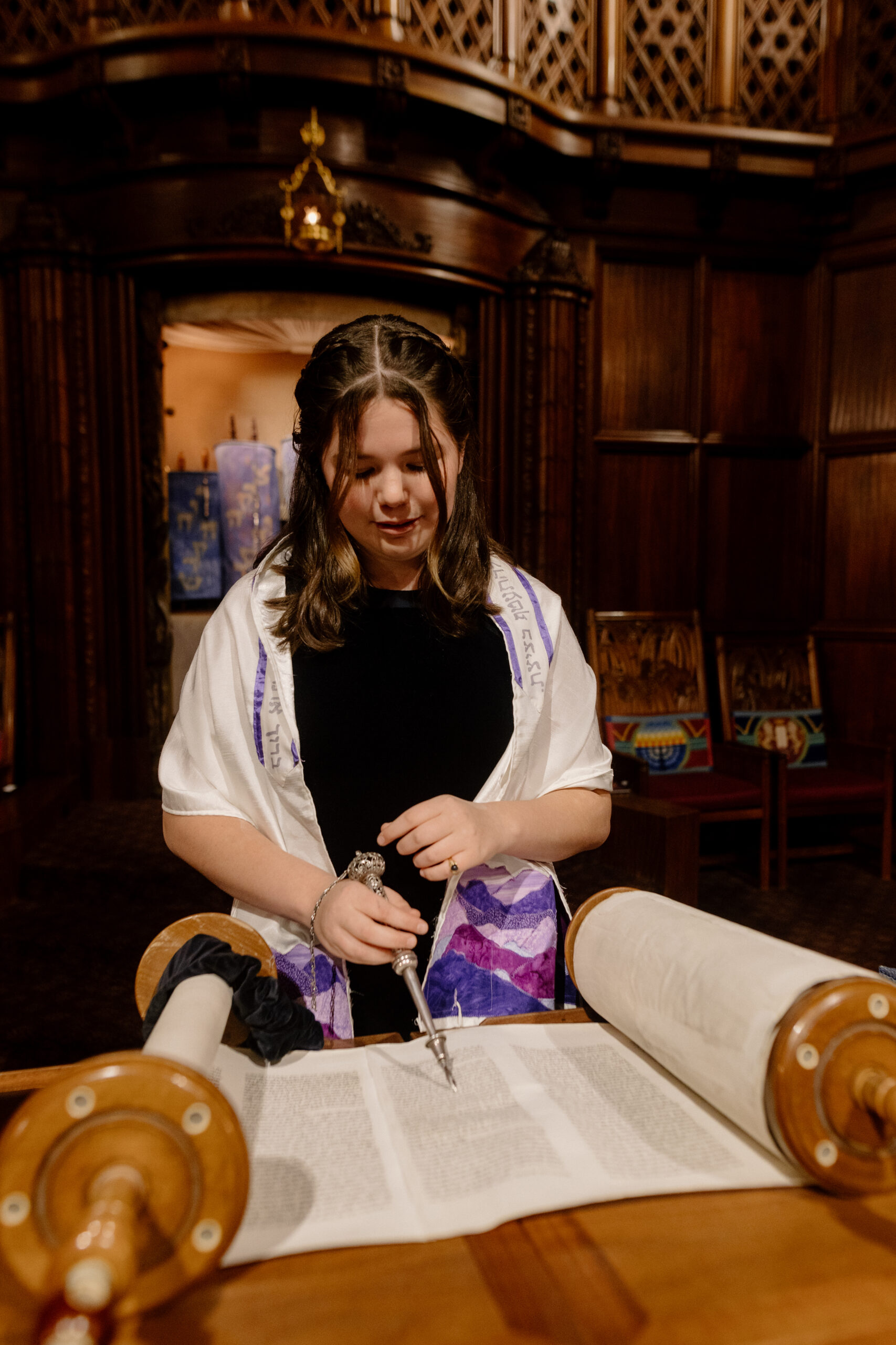 A child reads the torah during her bat mitzvah service at Congregation Beth Israel in Portland.