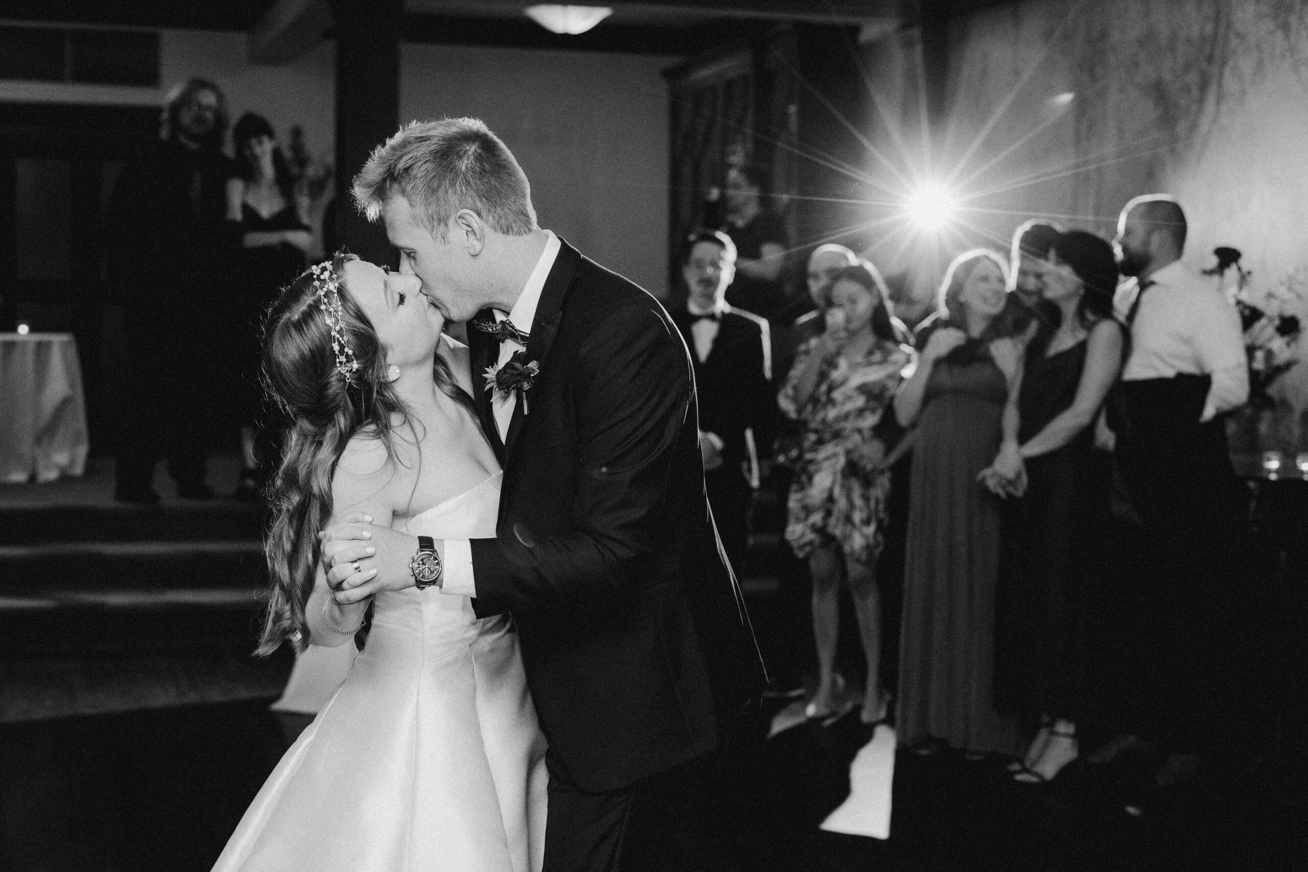 A bride and groom kiss during their first dance at their Portland wedding.