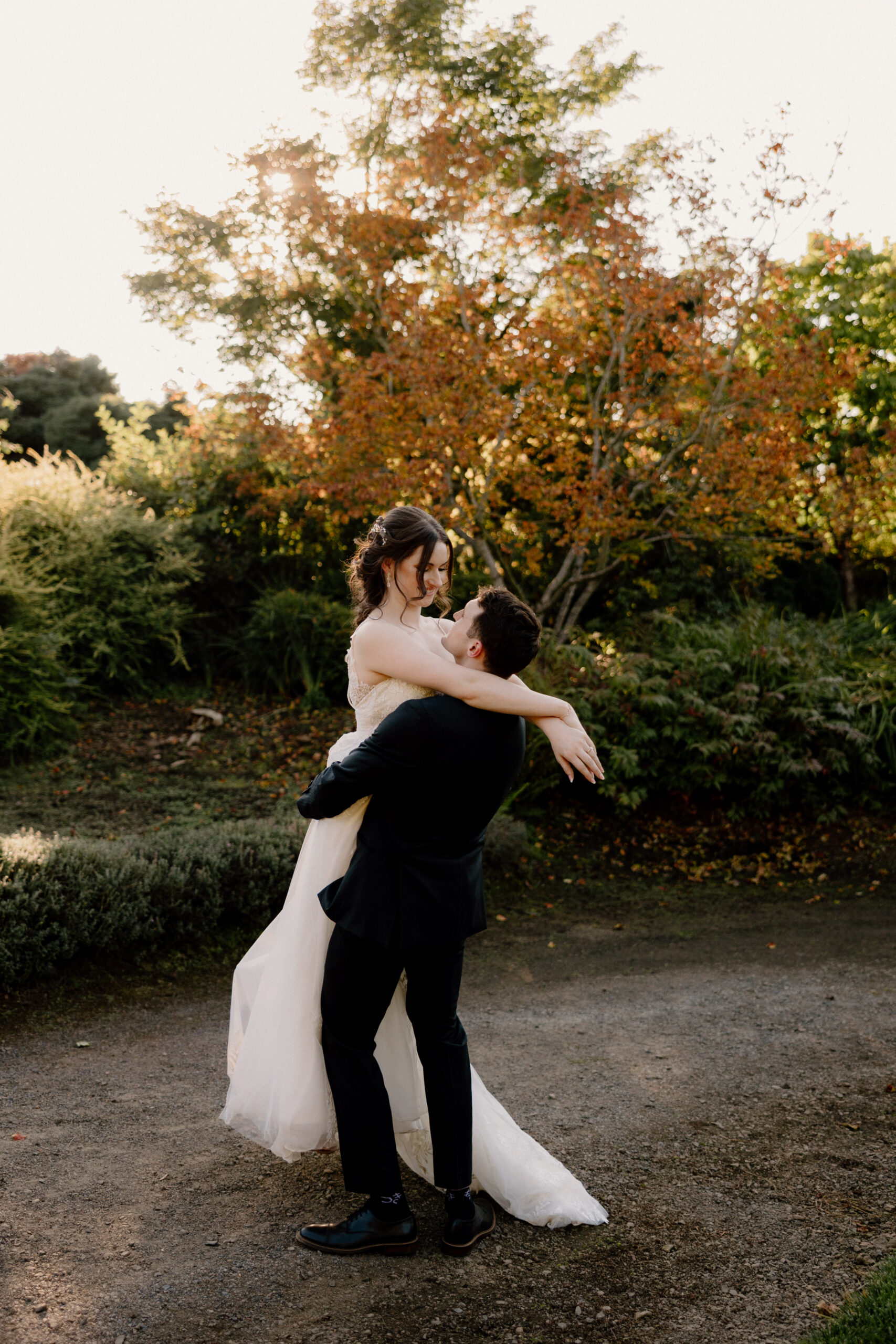 A bride and groom embrace at their Oregon Garden Resort wedding.